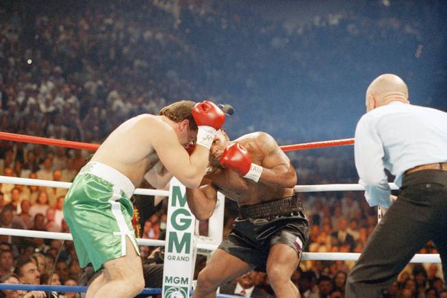 Former heavyweight champion Mike Tyson, right, hits Peter McNeeley with a right uppercut during the first round of their match in Las Vegas, Saturday, August 19, 1995. Tyson knocked McNeeley down twice during the round before McNeeley?s manager; Vinny Vecchione stepped into the ring and stopped the fight. Nevada state boxing regulators will decide this week whether to take action against Vecchione for his action. (AP Photo/Lennox McLendon)