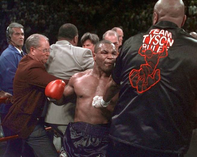 Mike Tyson continues to battle in the ring after his fight against Evander Holyfield was stopped after Tyson bit Holyfield on both ears, in the third round of their WBA Heavyweight match Saturday, June 28, 1997, at the MGM Grand in Las Vegas.  Tyson was disqualified and Holyfield retains his title.(AP Photo/Mark J. Terrill)