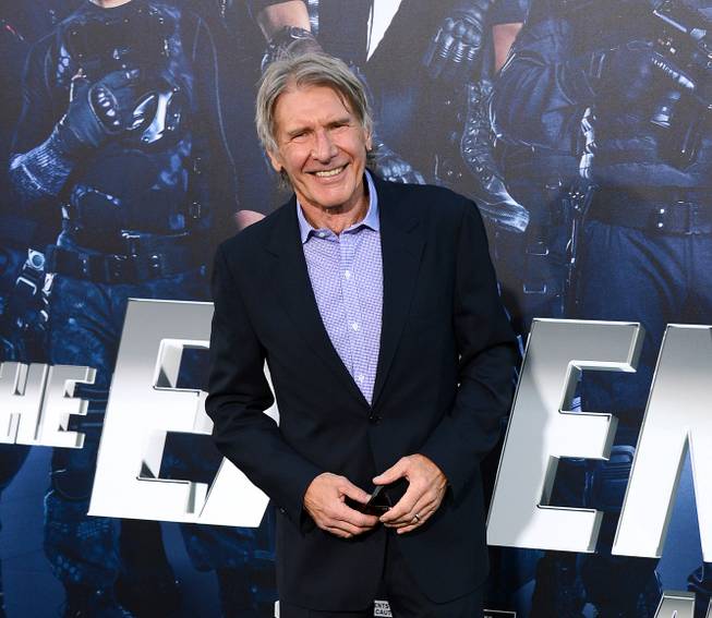 In this Aug. 11, 2014, photo, Harrison Ford arrives at the premiere of "The Expendables 3" at TCL Chinese Theater in Los Angeles. Ford is set to reprise his role as Rick Deckard in a sequel to the dystopian, neo-noir “Blade Runner” more than 31 years after the film first premiered, Alcon Entertainment announced Thursday, Feb. 26, 2015. 