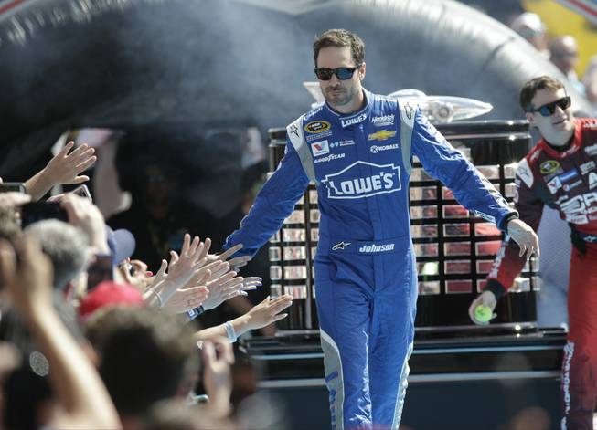 Jimmie Johnson greets fans as he is introduced before the start of the Daytona 500 NASCAR Sprint Cup series auto race at Daytona International Speedway in Daytona Beach, Fla., Sunday, Feb. 22, 2015.