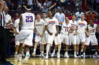 Bishop Gorman's Nick Blair (23) is cheered on by teammates after a tough basket and foul during the state title game Friday, Feb. 27, 2015.