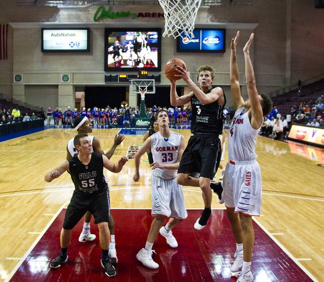 Palo Verde's Grant Dressler (5) gets to the basket between Bishop Gorman's Stephen Zimmerman (44) and Nick Blair (23) during the state basketball championship game on Friday, Feb. 27, 2015.
