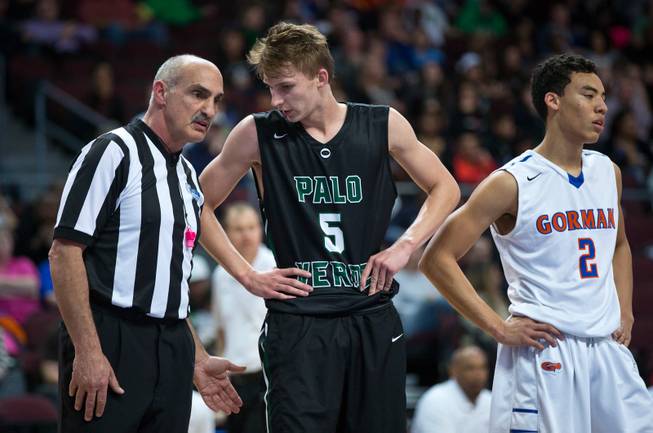 Palo Verde's Grant Dressler (5) confers with an official after a foul besides Bishop Gorman's Richie Thornton (2) during the NIAA Division 1 State Basketball Championships on Friday, February, 27, 2015.