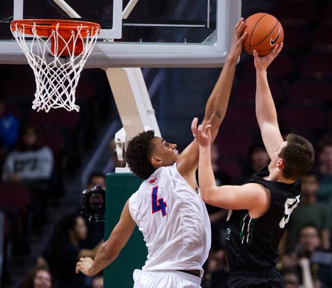 Bishop Gorman's Chase Jeter (4) rejects a shot by Palo Verde's Kyler Hack (55) during the NIAA Division I State Basketball Championships on Friday, February, 27, 2015.