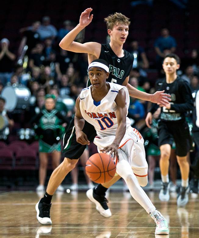 Bishop Gorman's Julian Payton (10) maneuvers past Palo Verde's Grant Dressler (5) while driving to the basket during the NIAA Division 1 State Basketball Championships on Friday, February, 27, 2015.