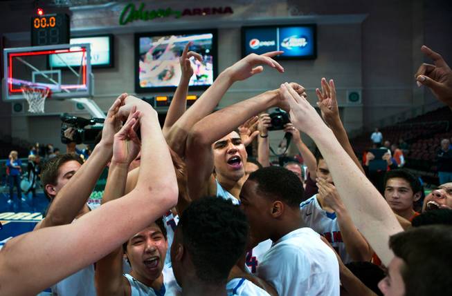 Bishop Gorman players celebrate their win over Palo Verde 74-54 during the NIAA Division 1 State Basketball Championships on Friday, February, 27, 2015.
