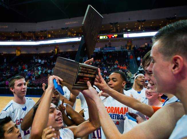 Bishop Gorman players celebrate their win over Palo Verde 74-54 during the NIAA Division I state basketball championship on Friday, Feb. 27, 2015.