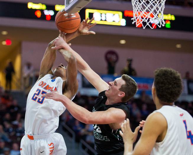 Bishop Gorman's Nick Blair (23) takes a hard foul from Palo Verde's Kyler Hack (55) during the NIAA Division 1 State Basketball Championships on Friday, February, 27, 2015.