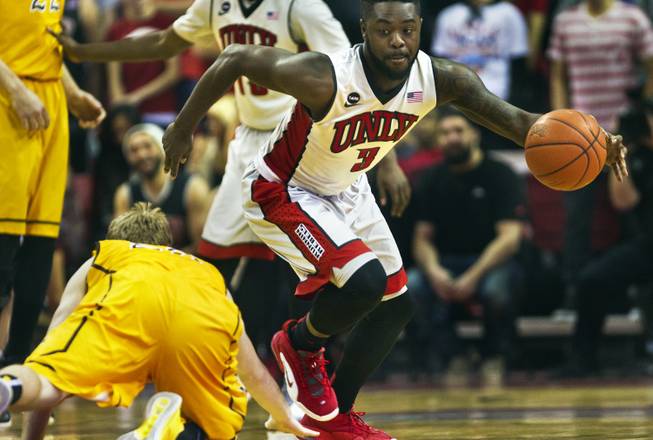 UNLV guard Jordan Cornish looks for the open court after stealing the ball from Wyoming guard Jason McManamen on Saturday, Feb., 28, 2015.