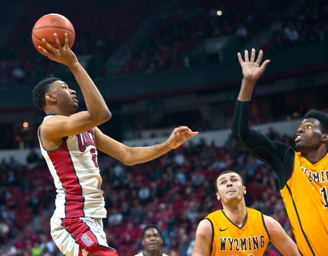 UNLV forward Christian Wood releases a touch shot over the defense of Wyoming forward Derek Cooke Jr., right, on Saturday, Feb. 28, 2015. 