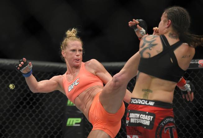 Holly Holm, left, connects with Raquel Pennington during a UFC 184 mixed martial arts bantamweight bout Saturday, Feb. 28, 2015, in Los Angeles. Holm won by split decision. 