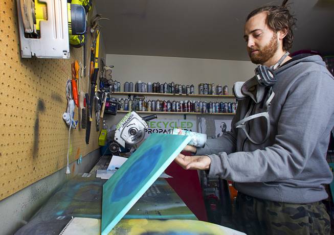 Artist Izaac Zevalking works in his studio Sunday, March 1, 2015, in Summerlin. Zevalking, the artist behind Recycled Propaganda, will be celebrating two years of being with First Friday on March 6.