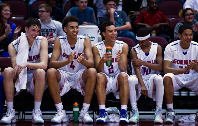 Bishop Gorman starters relax and enjoy the remainder of the game from the bench after a commanding lead late versus Palo Verde during the NIAA Division 1 State Basketball Championships on Friday, February, 27, 2015.
