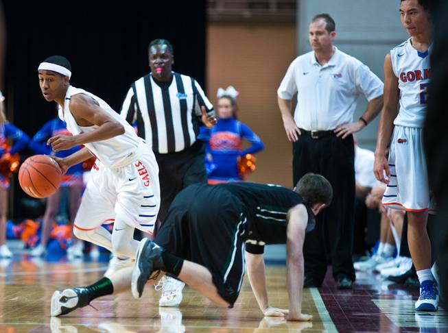 Bishop Gorman's Julian Payton (10) maneuvers around Palo Verde's Ryan Vogeli (24) who just missed grabbing a loose ball during the NIAA Division 1 State Basketball Championships on Friday, February, 27, 2015.