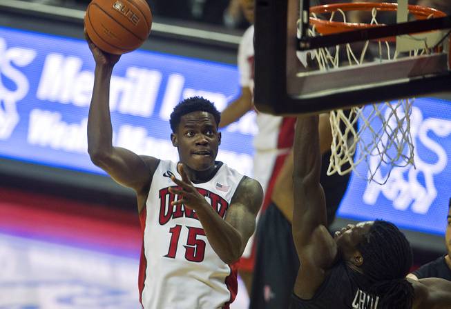 UNLV forward Dwayne Morgan takes a shot over San Diego State forward Angelo Chol at the Thomas & Mack Center in Las Vegas on Wednesday, March 4, 2015. 