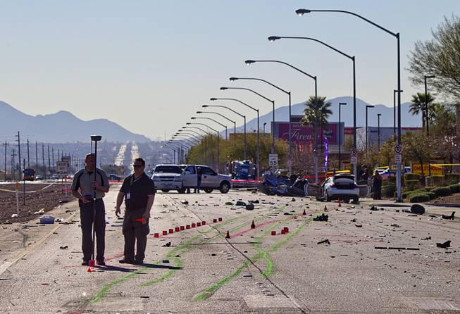 Metro Police investigators take measures at the scene of a fatal accident Thursday, March 5, 2015, on Boulder Highway. Two women were killed in the early morning accident. 