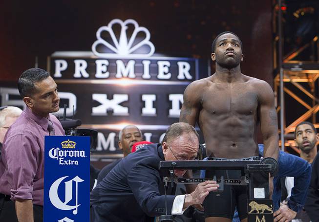 Super lightweight boxer Adrien Broner of Cincinnati, Ohio stands on the scale during an official weigh-in at the MGM Grand Garden Arena Friday, March 6, 2015. Broner will take on John Molina of Covina, Calif. at the arena Saturday. Bob Bennett, executive director of the Nevada State Athletic Commission, works the scale. The fight will be broadcast live on NBC Sports Network Saturday, March 7.