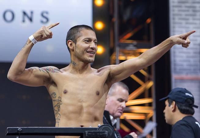 Featherweight boxer Arturo Santos Reyes of Nuevo Laredo, Mexico poses on the scale during an official weigh-in at the MGM Grand Garden Arena Friday, March 6, 2015. Reyes will take on Abner Mares of Guadalajara, Mexico at the arena Saturday. The fight will be broadcast live on NBC Sports Network.