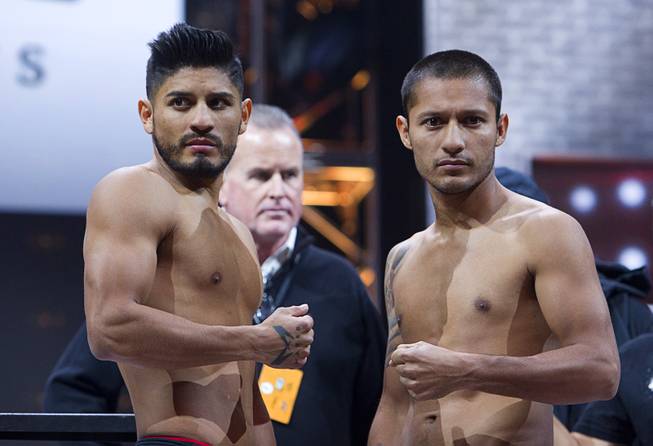 Featherweight boxers Abner Mares, left, of Guadalajara, Mexico and Arturo Santos Reyes of Nuevo Laredo, Mexico pose during an official weigh-in at the MGM Grand Garden Arena Friday, March 6, 2015. The fight will be broadcast live on NBC Sports Network Saturday, March 7.