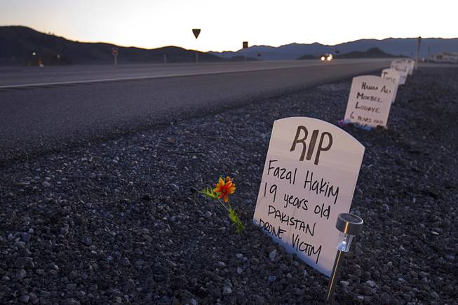 Mock headstones representing civilians killed by drone strikes are shown along U.S Highway 95 before an anti-drone protest at Creech Air Force Base, about 50 miles northwest of Las Vegas, March 6, 2015. About 100 people came out for the protest organized by the peace group CODEPINK. .