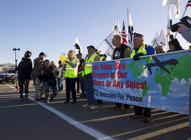 Ann Wright, left will megaphone, a former United States Army colonel and retired U.S. State Department official, reads a statement during an anti-drone protest at Creech Air Force Base, about 50 miles northwest of Las Vegas, March 6, 2015. About 100 people came out for the protest organized by the peace group CODEPINK. .