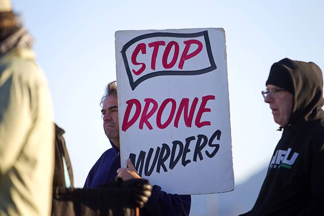 A protester hold a sign during an anti-drone protest at Creech Air Force Base, about 50 miles northwest of Las Vegas, March 6, 2015. About 100 people came out for the protest organized by the peace group CODEPINK. .