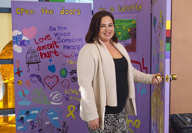 Christina Hernandez, director of the Jean Nidetch Women's Center at UNLV, poses at the center Friday, March 6, 2015. The purple doors are an art piece created during a "Take Back the Night" event in 2013. 