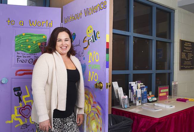 Christina Hernandez, director of the Jean Nidetch Women's Center at UNLV, poses at the center Friday, March 6, 2015. The purple doors are an art piece created during a "Take Back the Night" event in 2013. 
