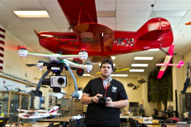 Student Mark Omo flies a small UAV about the room within the Rancho High School Academy of Aviation magnet program on Thursday, February 5, 2015. L.E. Baskow