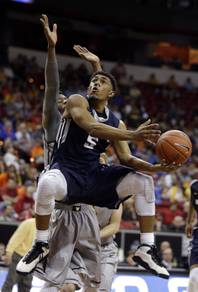 Utah State's Julion Pearre, front, shoots while covered by Wyoming's Derek Cooke Jr. during the first half of an NCAA college basketball game in the quarterfinal round of the Mountain West Conference tournament Thursday, March 12, 2015, in Las Vegas.