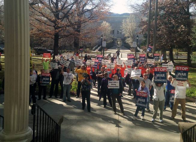 Dozens are shown at a union rally in front of the Capitol and Legislature in Carson City, Thursday, March 12, 2015.
