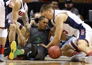 Arizona's Kaleb Tarczewski, right, and Oregon's Joseph Young battle for the ball during the second half of an NCAA college basketball game in the championship of the Pac-12 conference tournament Saturday, March 14, 2015, in Las Vegas. Arizona won 80-52.