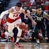 Wisconsin's Duje Dukan, left, and Michigan State's Denzel Valentine chase down a loose ball in the championship of the Big Ten Conference tournament in Chicago on Sunday, March 15, 2015.