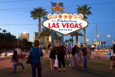 Tourists take photos at the Welcome to Fabulous Las Vegas sign Saturday, March 14, 2015, on the Strip.