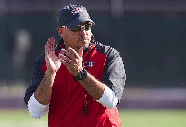 Head Coach Tony Sanchez watches UNLV football spring practice at Rebel Field Monday, March 16, 2015.
