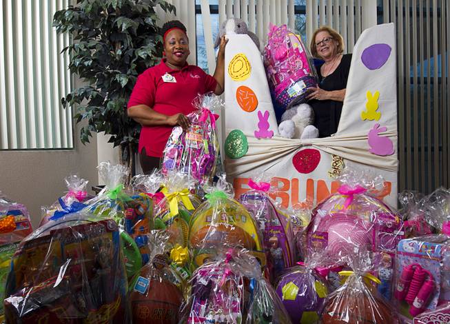 Vanessa Winchester, left, a day activities coordinator at Opportunity Village, and Barbara Kenig, founder of E Bunny, pose with donated Easter baskets at Opportunity Village’s Billy Walters campus. E Bunny collects Easter baskets for homeless youths and needy families in the valley.