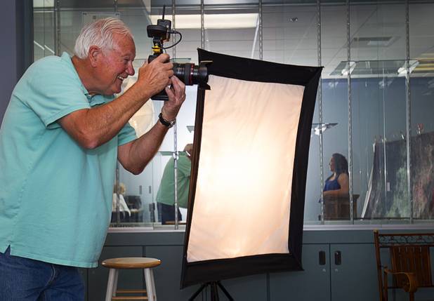 Jim Ziegler of Sandstone Photography takes a photo of  graduating senior during a portrait session at Canyon Springs High School in North Las Vegas Tuesday, March 17, 2015. Jim and his wife Anita volunteer their time to take free photos of selected graduating seniors who otherwise can't afford to have them taken.