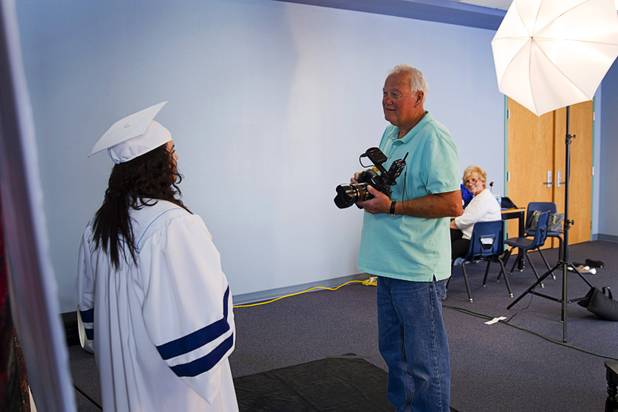 Jim Ziegler of Sandstone Photography talks with a student during a portrait session at Canyon Springs High School in North Las Vegas. 