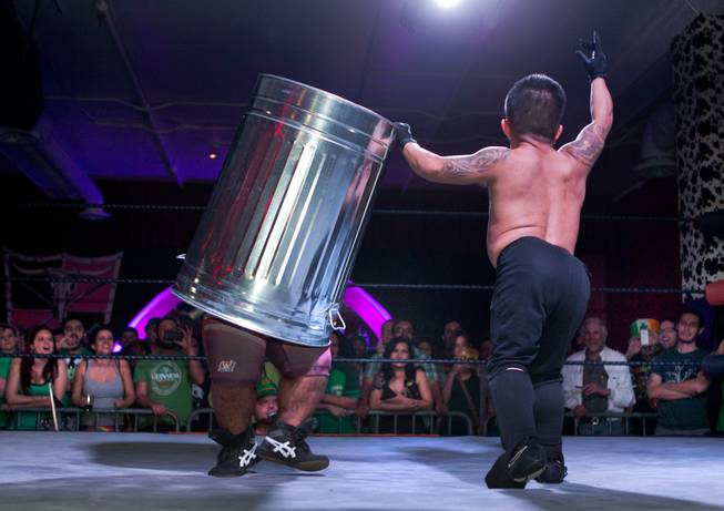 Wrestler Ricky Benjamin is trash canned by opponent J-Mazing during their match in the St. Patricks Day Leprechaun Smackdown by Midgets Unleashed at the Fremont Country Club on Tuesday, March, 17, 2015.