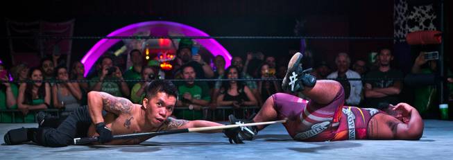 Wrestler J-Mazing looks to the crowd for permission to strike opponent Ricky Benjamin in the crotch during their match in the St. Patricks Day Leprechaun Smackdown by Midgets Unleashed at the Fremont Country Club on Tuesday, March, 17, 2015.