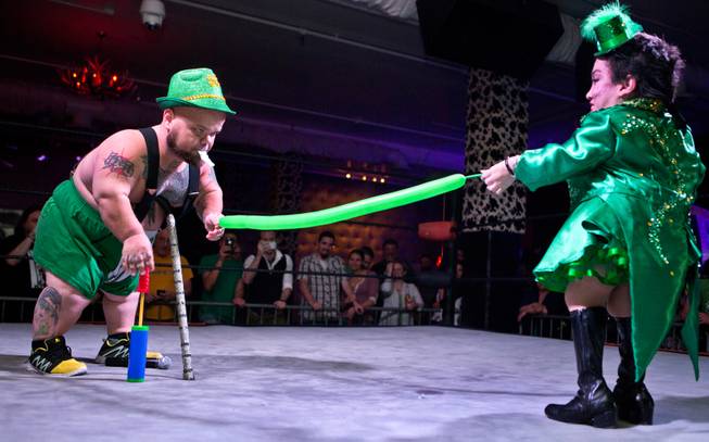 MC Turtle assists his wife Firefly for her upcoming balloon stunt in the ring during the St. Patricks Day Leprechaun Smackdown by Midgets Unleashed at the Fremont Country Club on Tuesday, March, 17, 2015.
