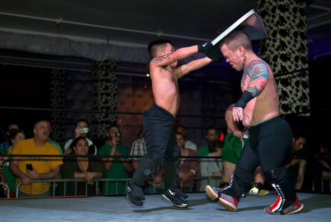 Wrestler J-Mazing slams a cooking tray to the head of opponent Smalls during their final match in the St. Patricks Day Leprechaun Smackdown by Midgets Unleashed at the Fremont Country Club on Tuesday, March, 17, 2015.