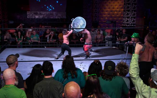 Wrestler J-Mazing is struck with a trash can by opponent J-Mazing during their battle royal match in the St. Patricks Day Leprechaun Smackdown by Midgets Unleashed at the Fremont Country Club on Tuesday, March, 17, 2015.