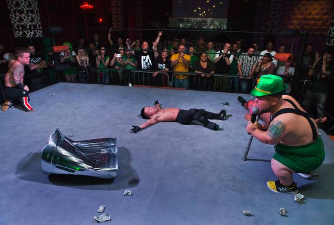 Wrestler Smalls is the last man standing with opponents Ricky Benjamin and J-Mazing down on the canvas ending their battle royal match on Tuesday, March, 17, 2015. MC Turtle makes the final call in the St. Patricks Day Leprechaun Smackdown by Midgets Unleashed at the Fremont Country Club.