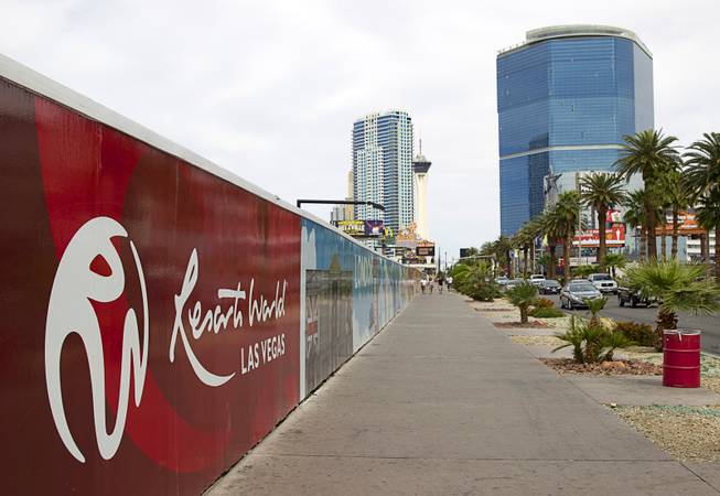 A sign, left, hides the unfinished Echelon project, now owned by the Genting Group, on Sunday, March 22, 2015. At right, is the stalled Fountainebleau casino project. Carl Icahn assumed part-ownership of the Fountainebleau on Feb. 18, 2010.