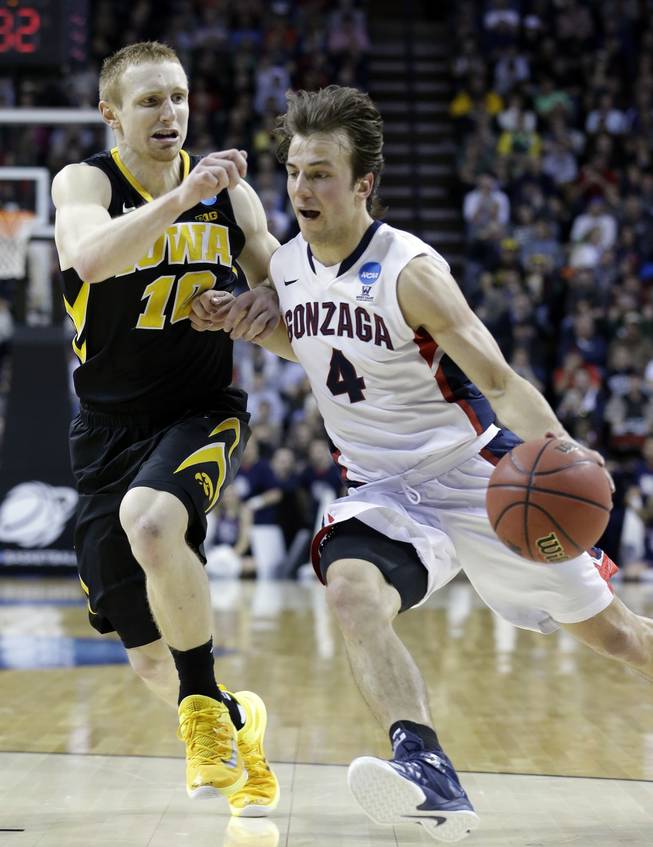Gonzaga's Kevin Pangos, right, drives against Iowa's Mike Gesell during the first half of an NCAA tournament college basketball game in the Round of 32 in Seattle on Sunday, March 22, 2015. 