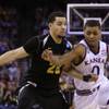 Kansas guard Frank Mason III, right, tries to drive past Wichita State guard Fred Van Vleet during the second half of an NCAA Tournament Round of 32 basketball game Sunday, March 22, 2015, in Omaha, Neb.