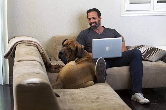 Former Clark County Commissioner Dario Herrera works at home with his dog Kaaya, a 3-year-old Tosa, in Las Vegas Tuesday, March 24, 2015. Herrera is getting past his conviction in the G-Sting political corruption scandal and is co-founder of Acento Digital Media, a social media company.