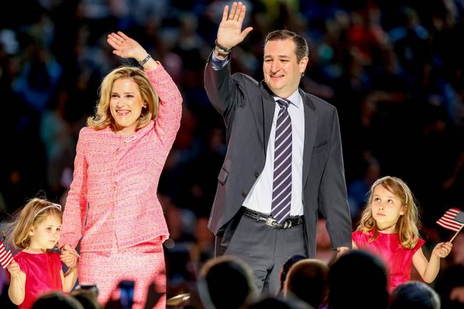 Sen. Ted Cruz, R-Texas, his wife, Heidi, and their two daughters Catherine, left, 4, and Caroline, 6, wave on stage after he announced his campaign for president, Monday, March 23, 2015, at Liberty University in Lynchburg, Va.