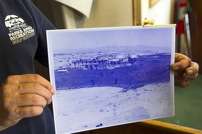 A Parks and Recreation employee holds an undated historic photo of the golf course at the Municipal Par 3 Golf Course, 324 E Brooks Ave., in North Las Vegas Wednesday, March 25, 2015. The photo was probably taken in the 1960's or early 1970's, he said.
